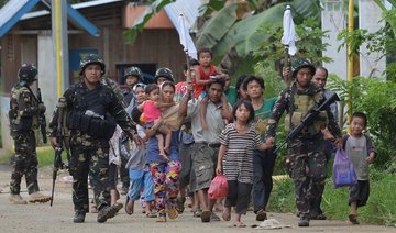 Philippines says militants keep up week-long fight with prisoners, looted guns