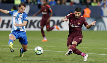 Barcelona stroll past Malaga without Messi