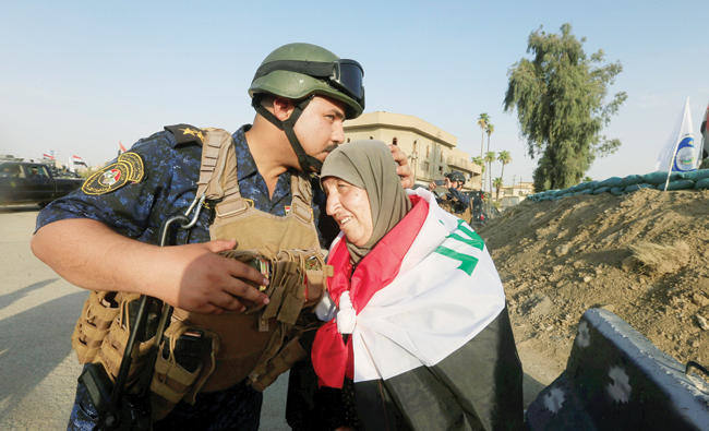 Exhausted and mourning, families emerge from Mosul ruins