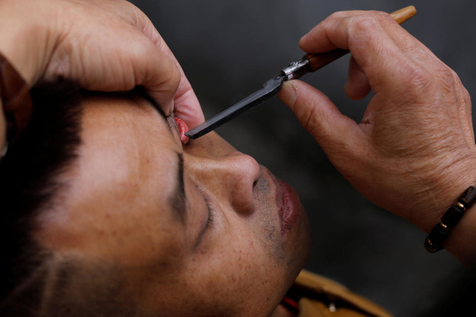 Flipping lids! Chinese barber offers eyelid shaves