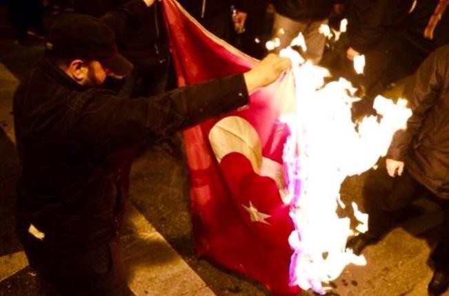 Turkey wants Greece to arrest protesters for burning flag