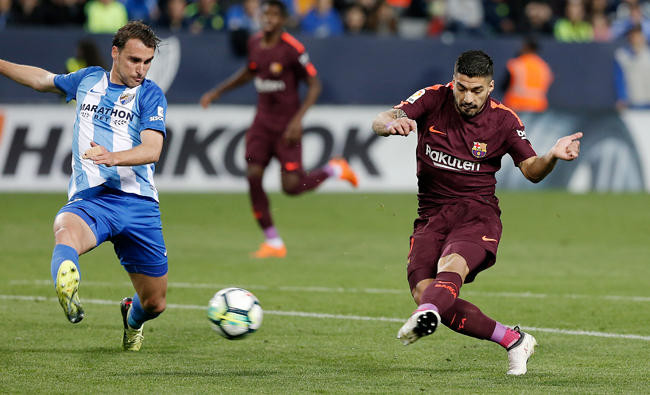 Barcelona stroll past Malaga without Messi